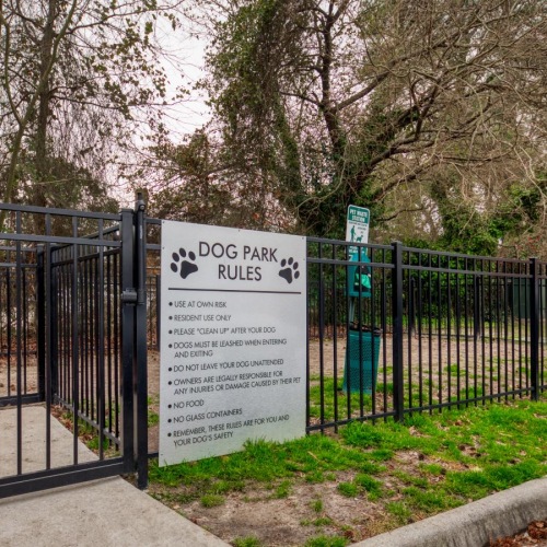 We welcome all your furry friends a gate with a sign on it