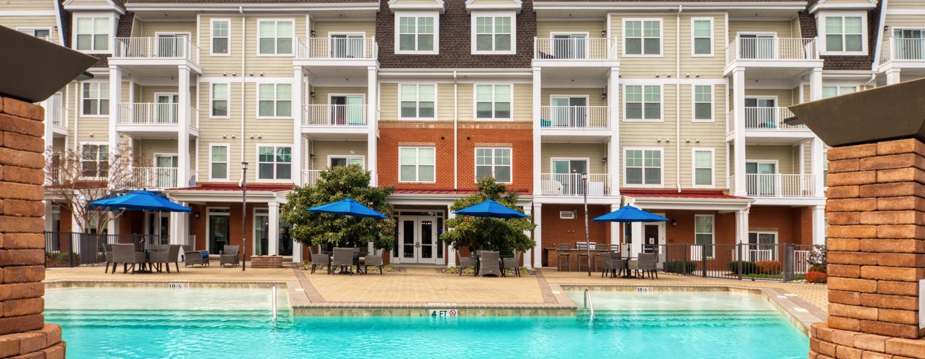 a large building with a pool in front of it