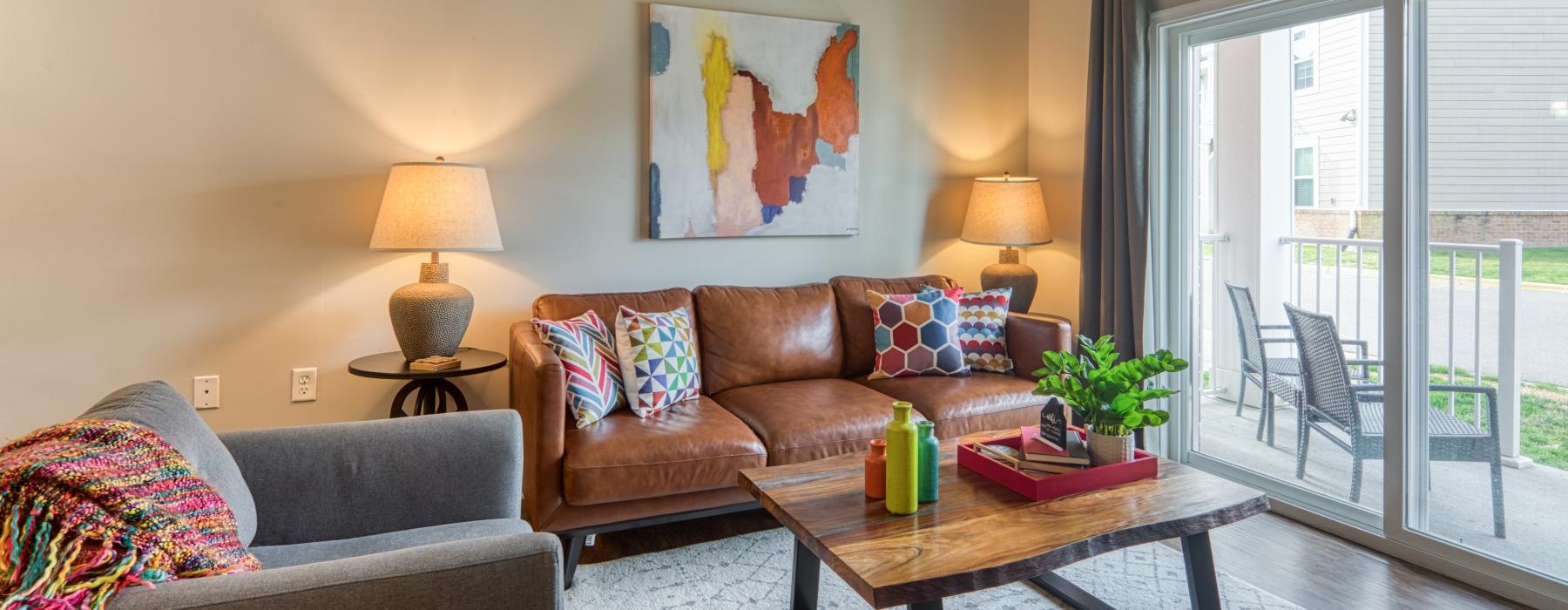 a living room with a couch coffee table and a painting on the wall