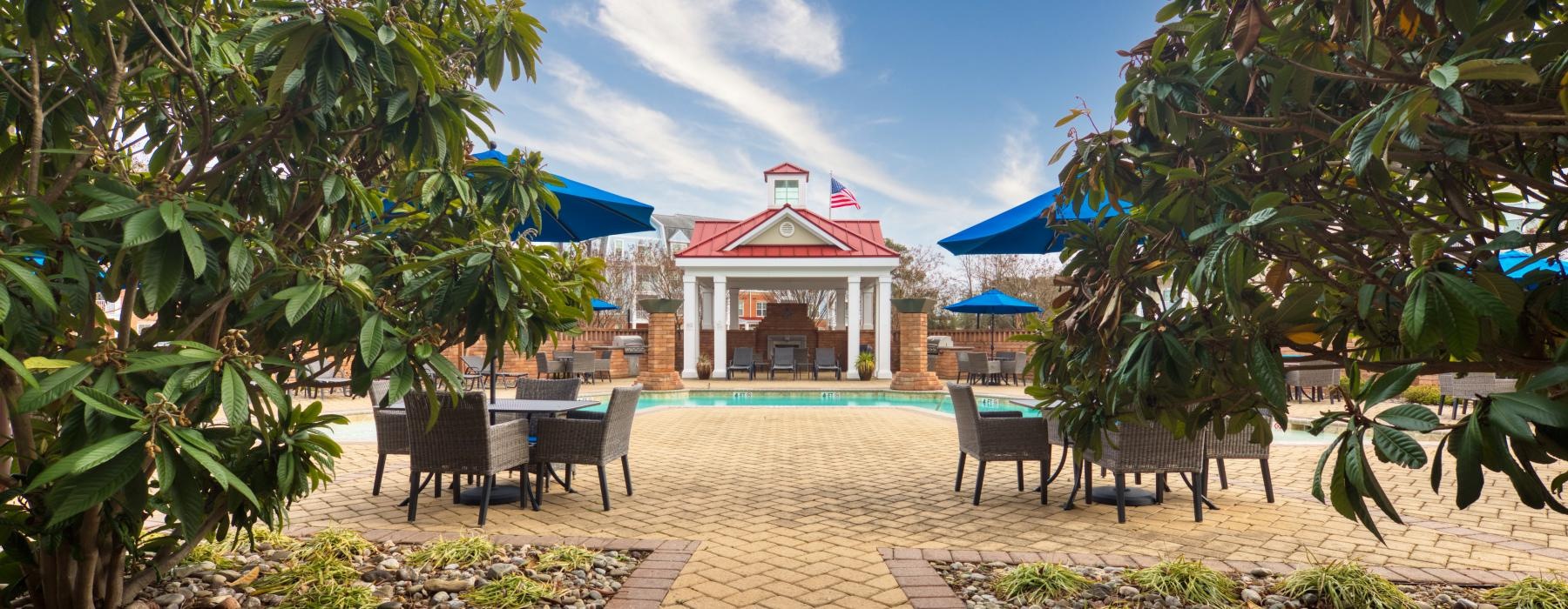 a courtyard with tables and chairs